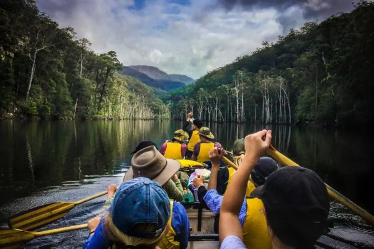 Students paddling canoes together on a river during a Southbound school program
